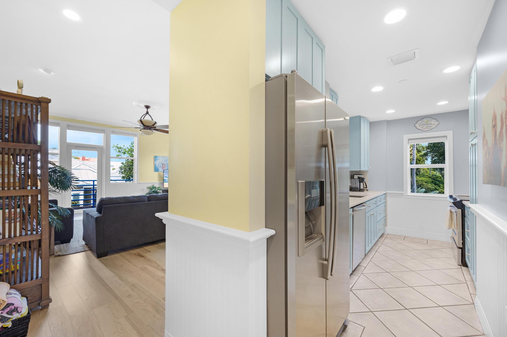 115 Front Street, Unit 301 Key West, FL 33040 - Photo 11 of 52 a kitchen with a refrigerator and a sink