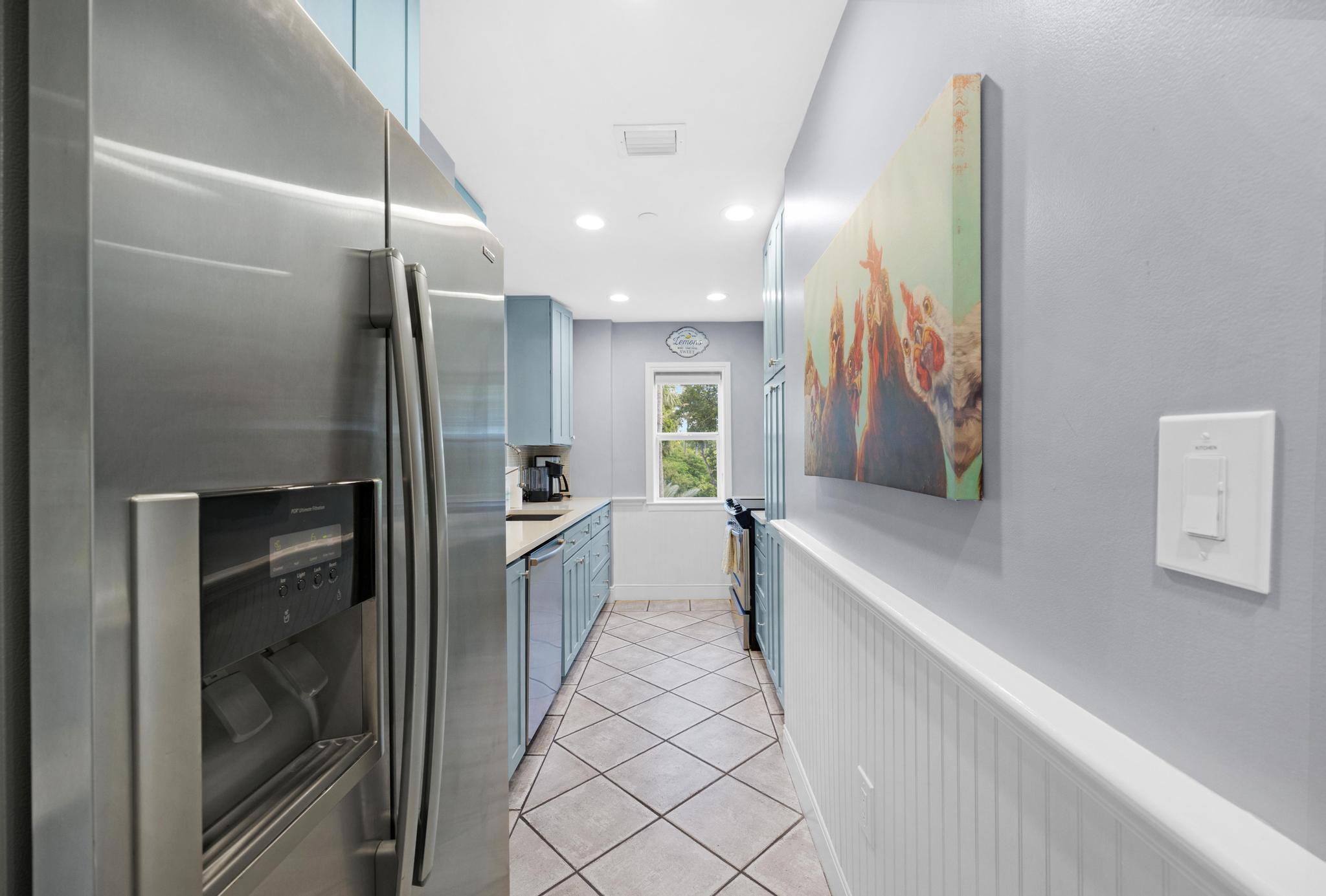 115 Front Street, Unit 301 Key West, FL 33040 - Photo 12 of 52 a large white kitchen with a sink and refrigerator