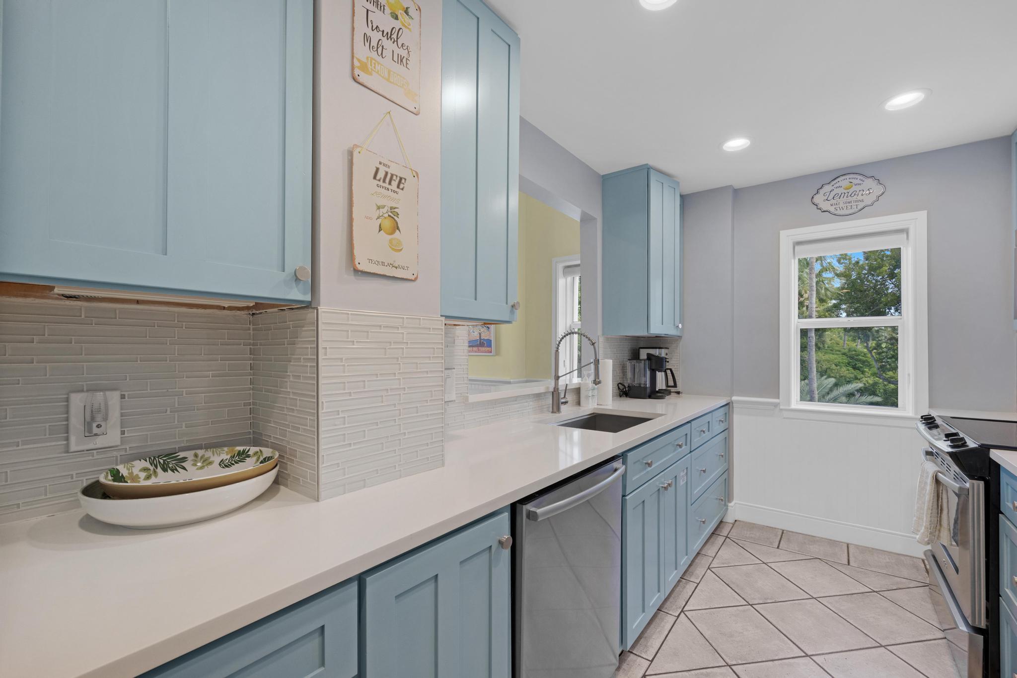 115 Front Street, Unit 301 Key West, FL 33040 - Photo 13 of 52 a kitchen with a sink and cabinets