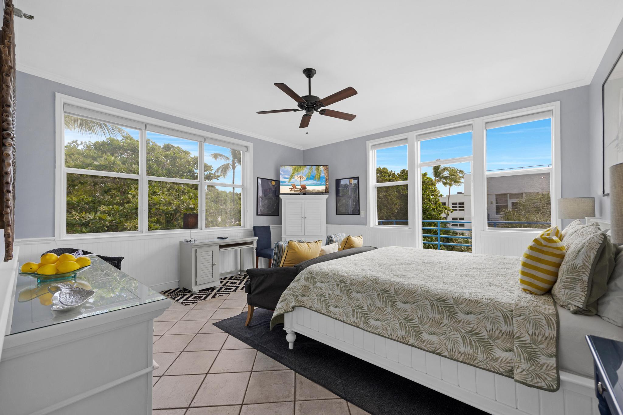 115 Front Street, Unit 301 Key West, FL 33040 - Photo 28 of 52 a bedroom with a bed and large windows