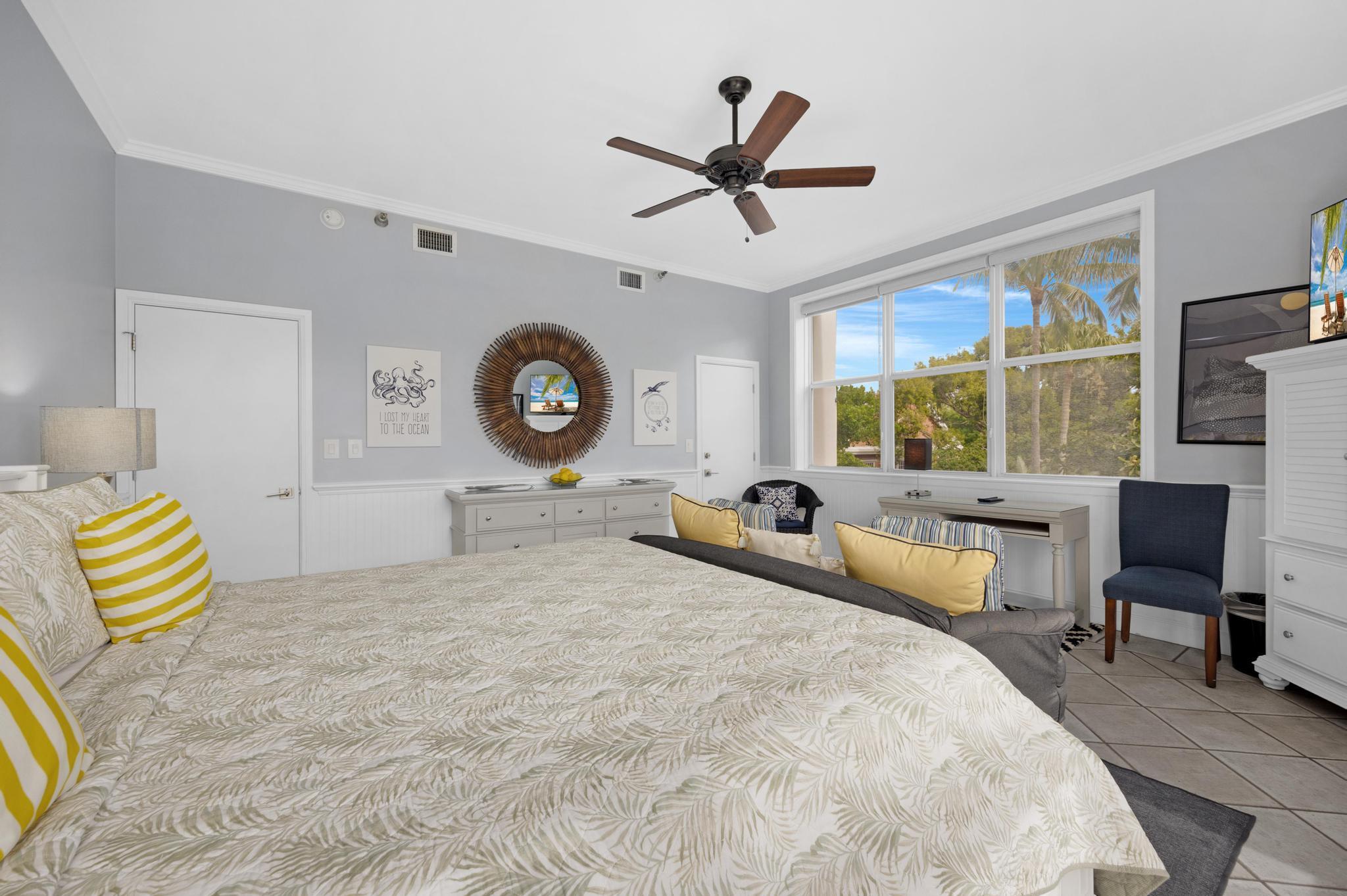 115 Front Street, Unit 301 Key West, FL 33040 - Photo 31 of 52 a bed room with a bed and a chair