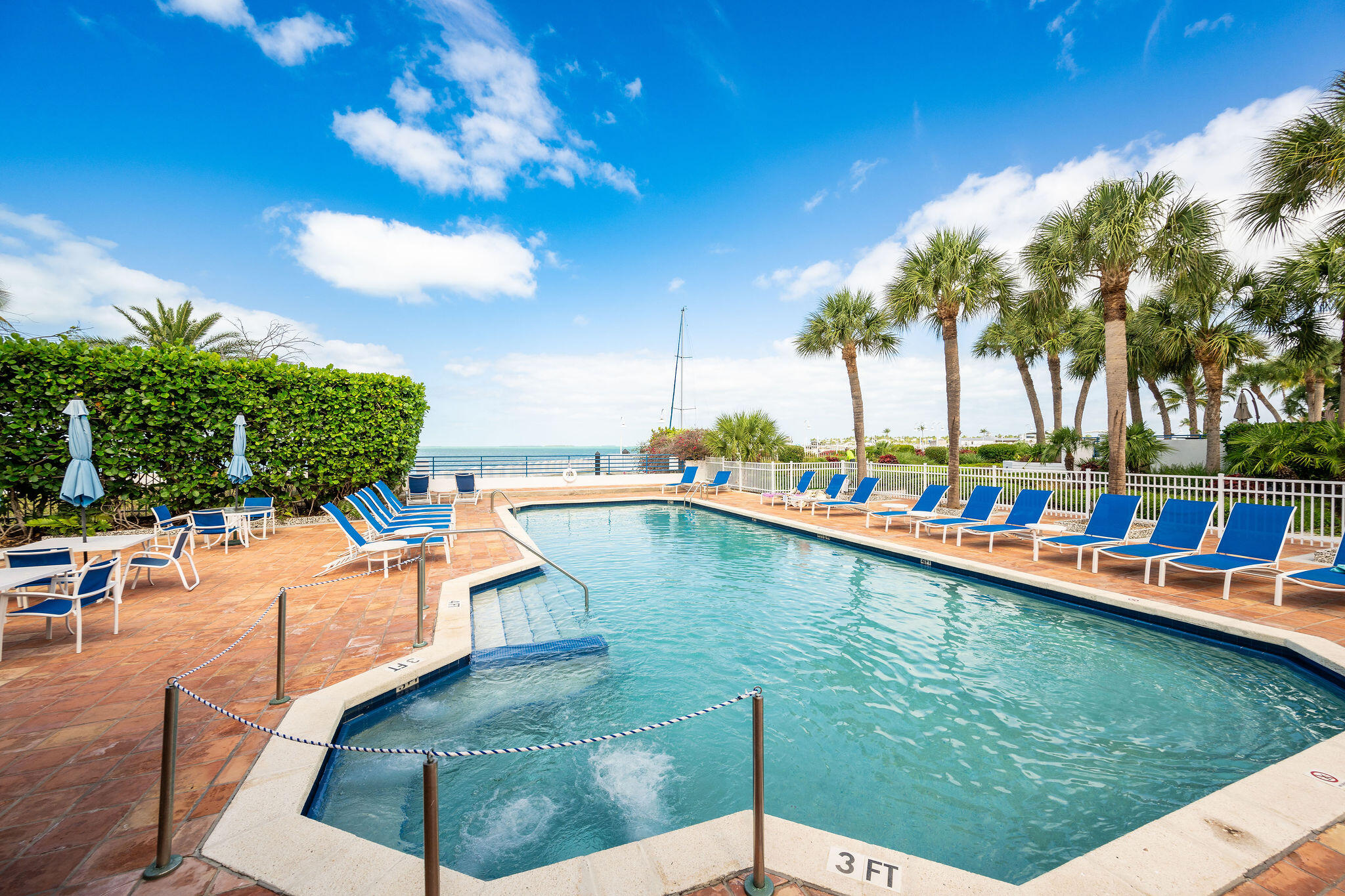 115 Front Street, Unit 301 Key West, FL 33040 - Photo 49 of 52 a view of a swimming pool and lounge chairs