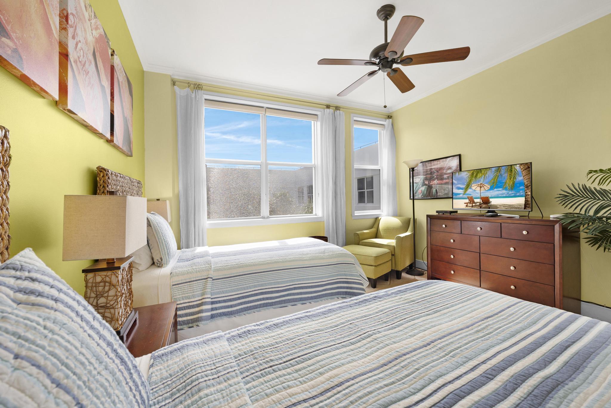 115 Front Street, Unit 301 Key West, FL 33040 - Photo 5 of 52 a bedroom with a bed dresser and a window