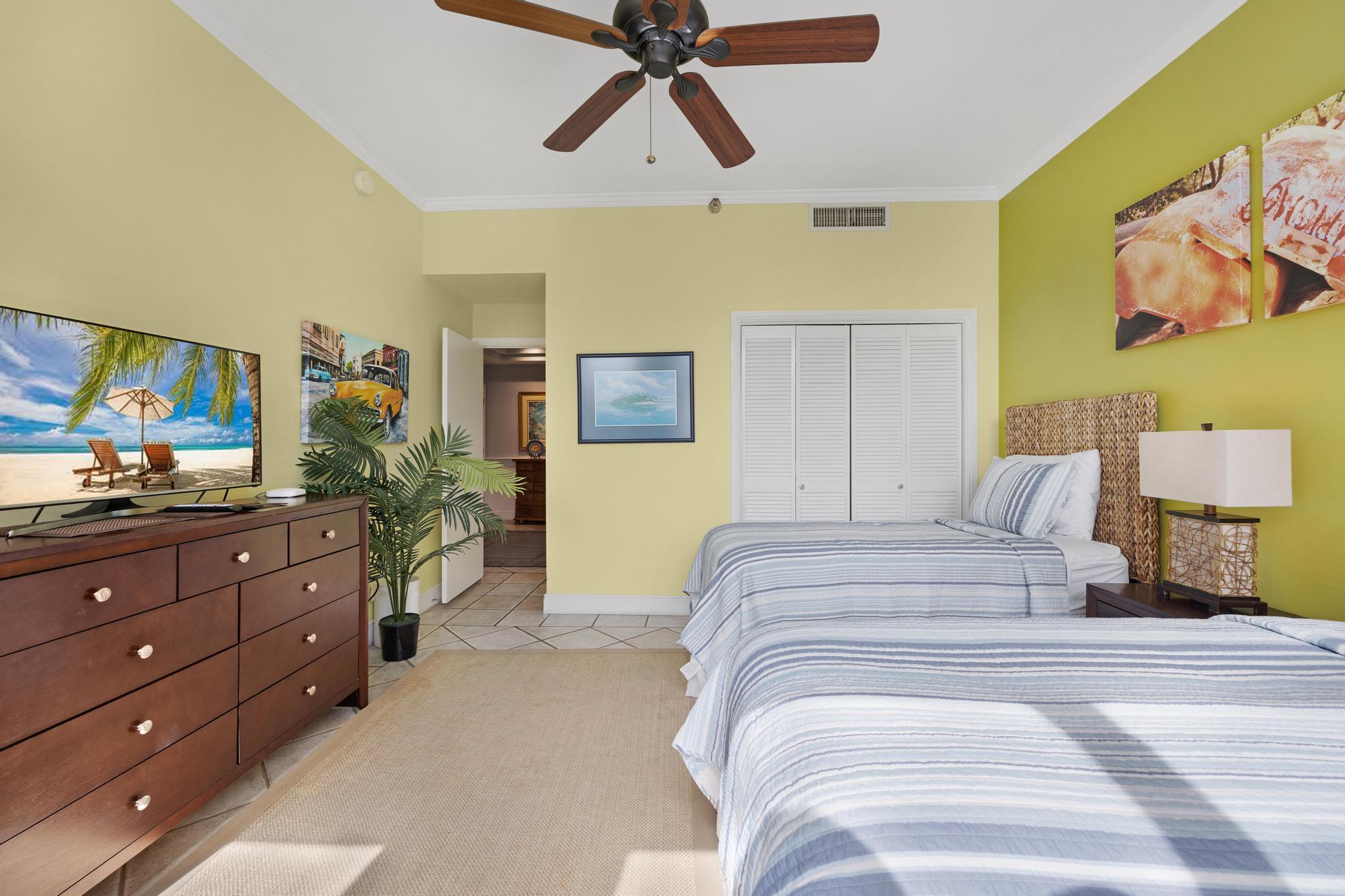 115 Front Street, Unit 301 Key West, FL 33040 - Photo 6 of 52 a bedroom with a bed and a flat screen tv