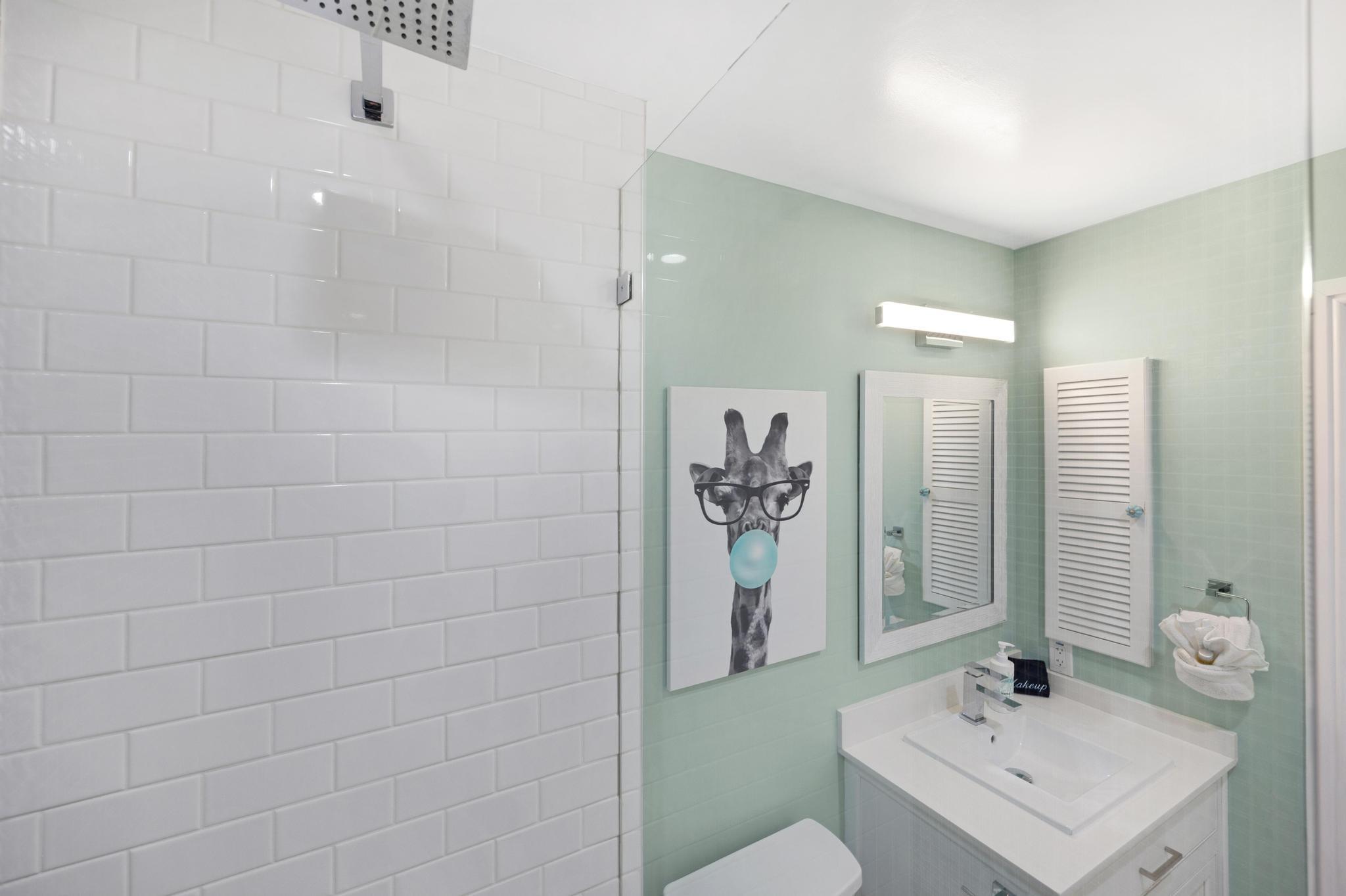 115 Front Street, Unit 301 Key West, FL 33040 - Photo 7 of 52 a bathroom with a sink a toilet and shower