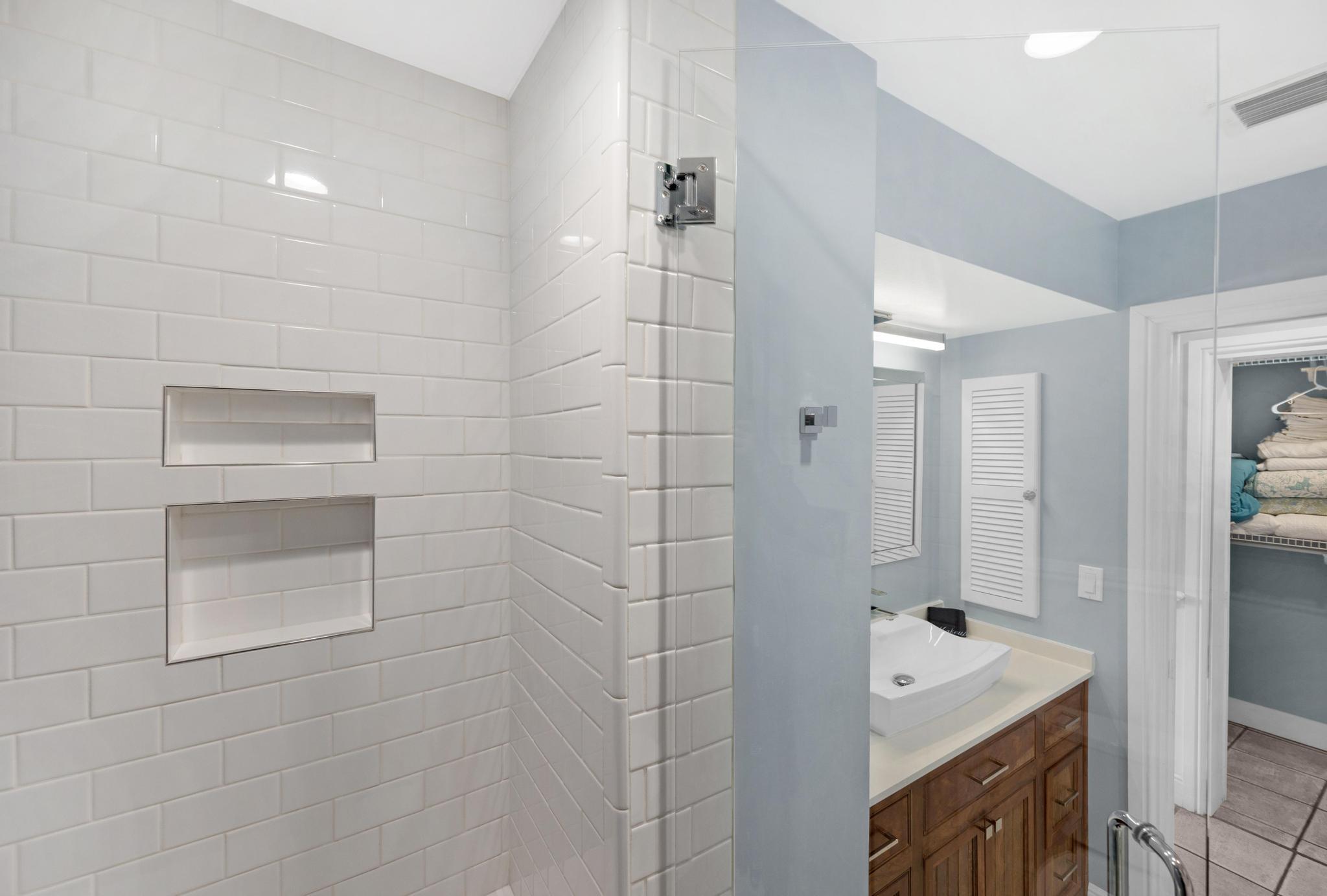 115 Front Street, Unit 301 Key West, FL 33040 - Photo 8 of 52 a bathroom with a tub sink and mirror
