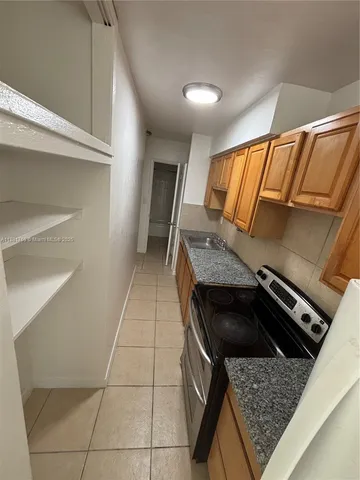 a kitchen with granite countertop a stove and a sink