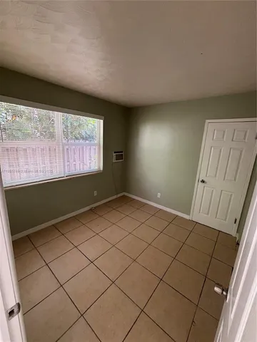 a view of an empty room and a window