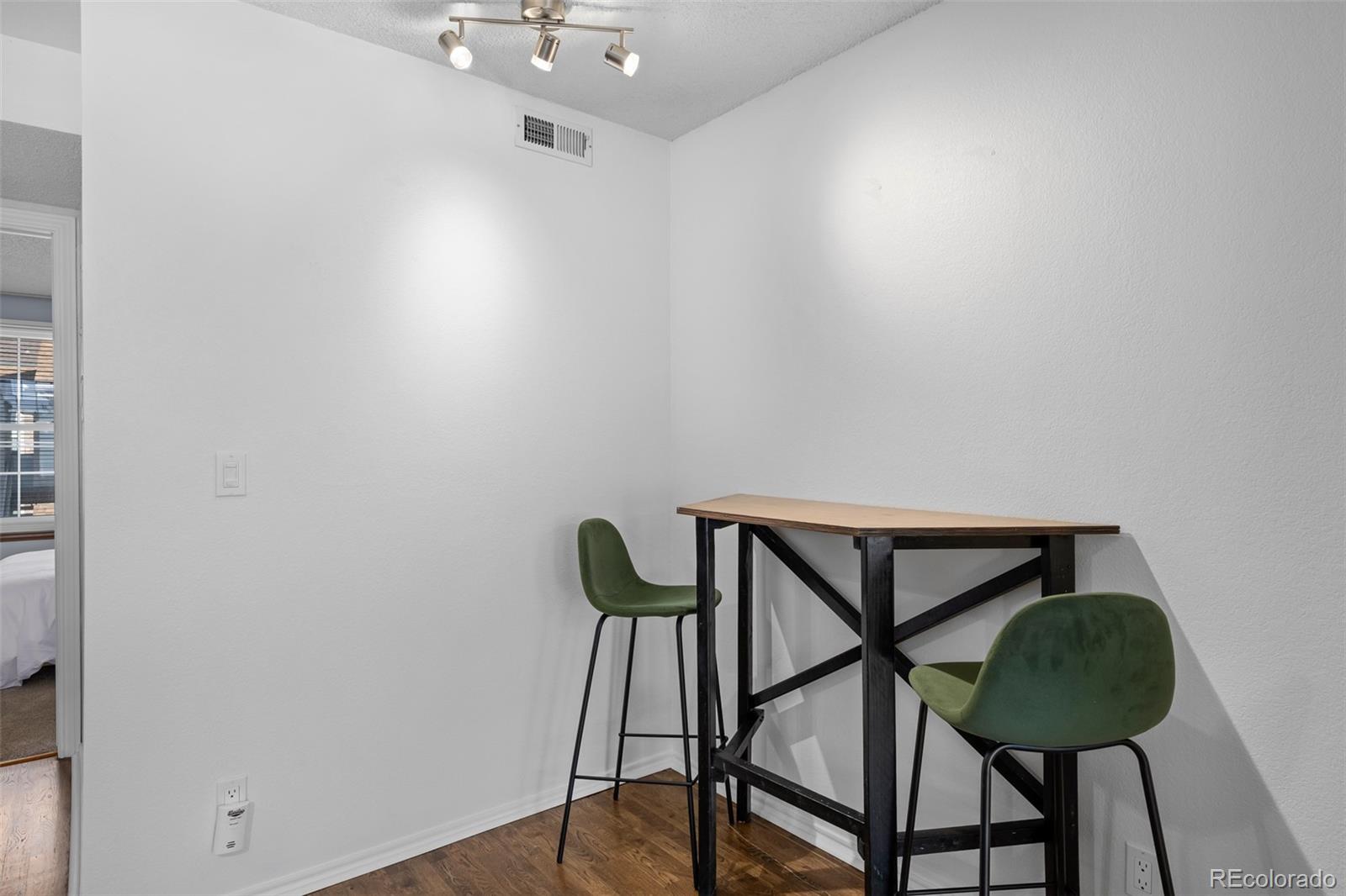 3016 West Prentice Avenue, Unit D Littleton, CO 80123 - Photo 11 of 28 a view of a room with furniture and wooden floor