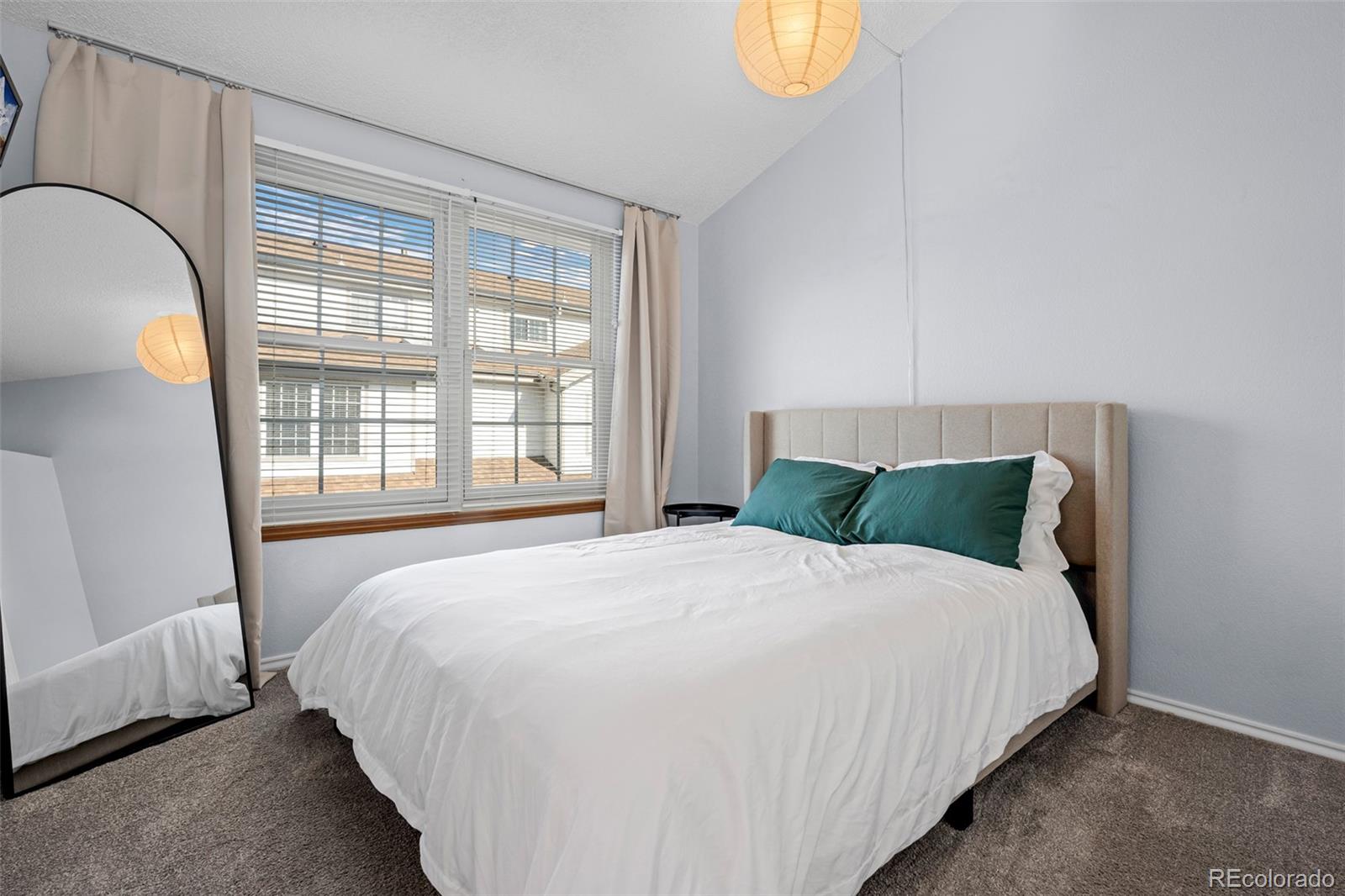 3016 West Prentice Avenue, Unit D Littleton, CO 80123 - Photo 12 of 28 a large bed sitting in a bedroom next to a window