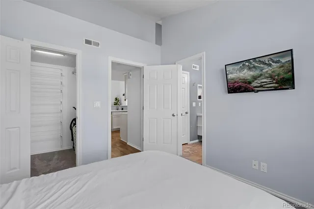 a bedroom with a bed and a painting on the wall