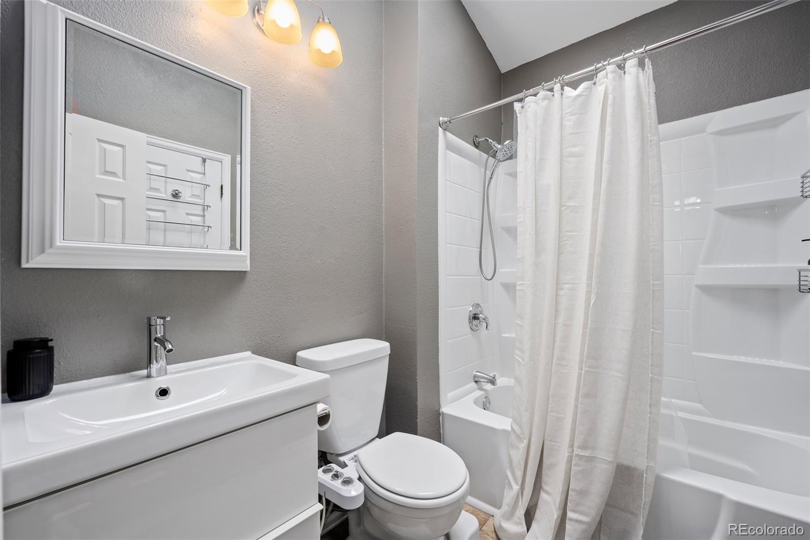 3016 West Prentice Avenue, Unit D Littleton, CO 80123 - Photo 16 of 28 a bathroom with a sink a toilet and shower