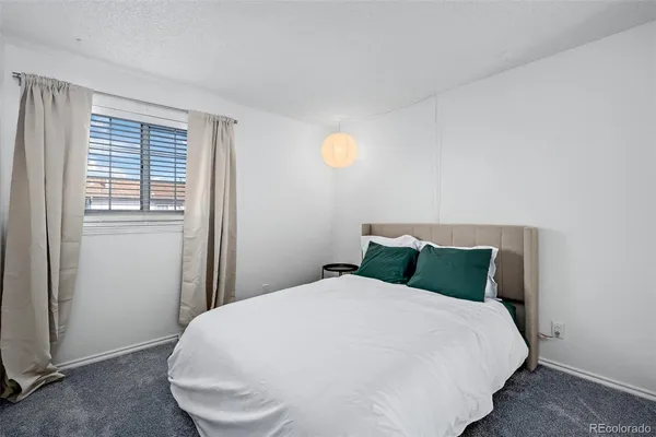 a bedroom with a bed and window
