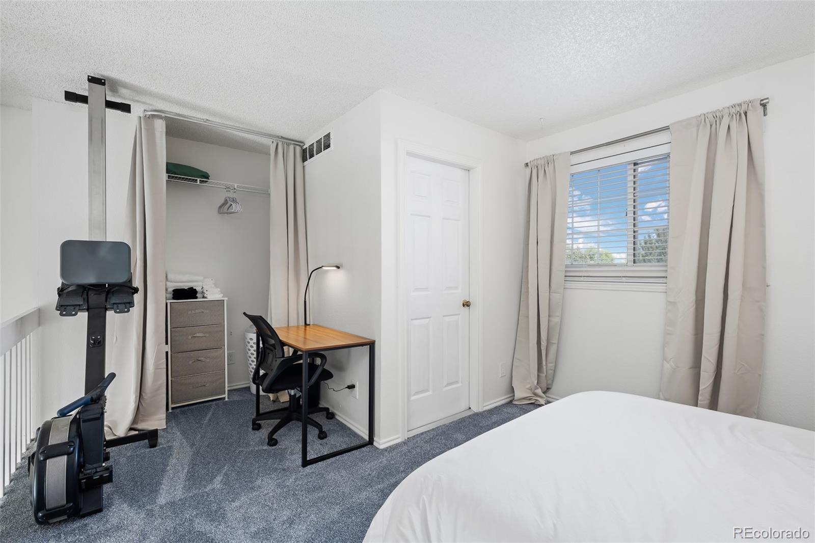 3016 West Prentice Avenue, Unit D Littleton, CO 80123 - Photo 18 of 28 a bedroom with a chair and a desk