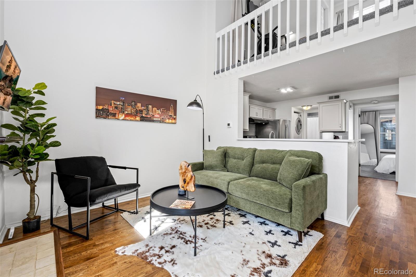 3016 West Prentice Avenue, Unit D Littleton, CO 80123 - Photo 2 of 28 a living room with furniture and a rug