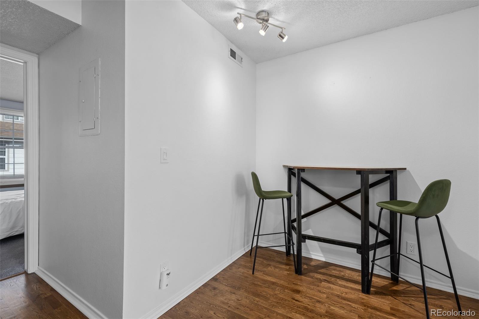 3016 West Prentice Avenue, Unit D Littleton, CO 80123 - Photo 27 of 28 a view of a room with furniture and wooden floor