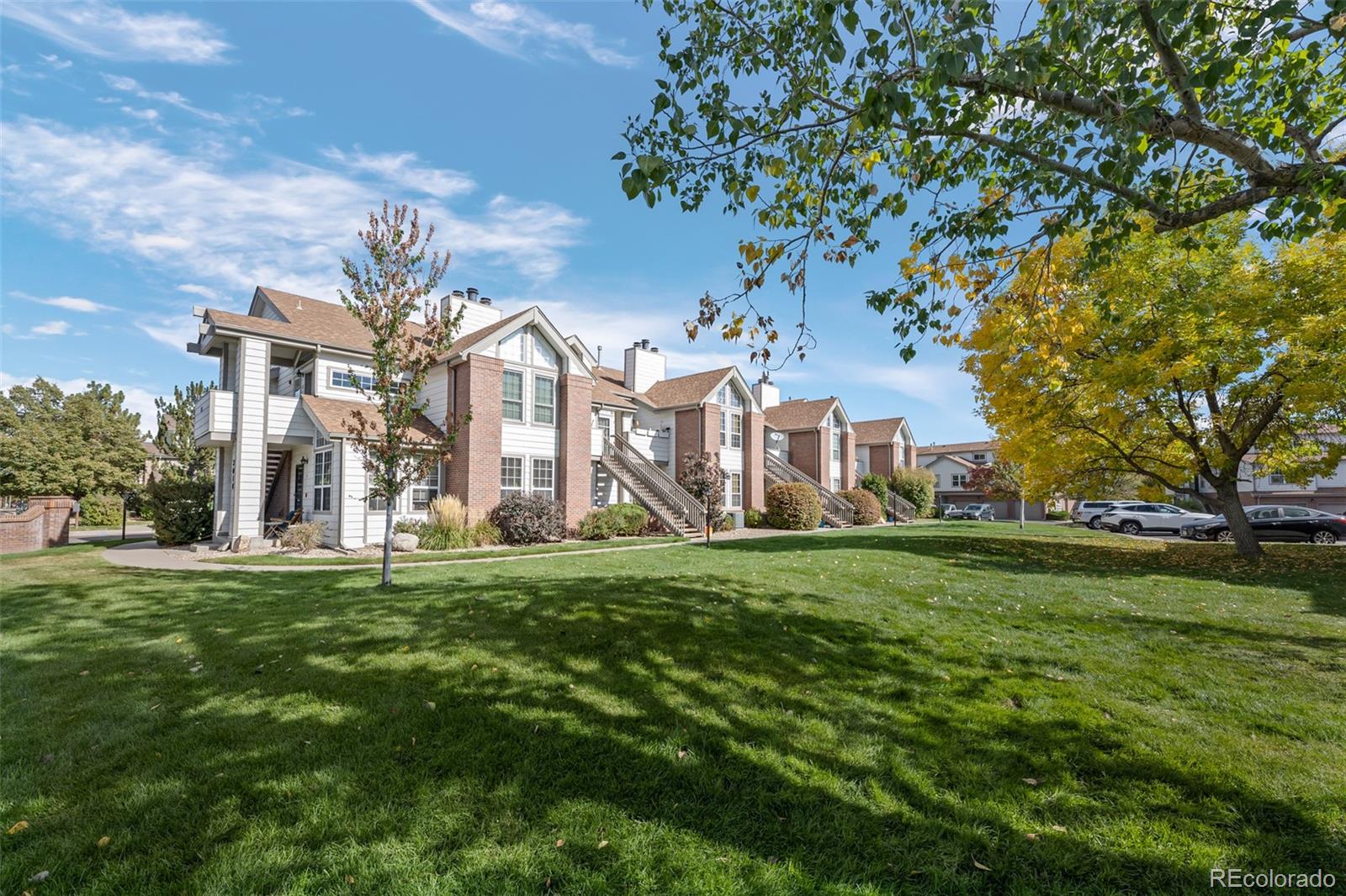 3016 West Prentice Avenue, Unit D Littleton, CO 80123 - Photo 28 of 28 a large building with a big yard and more large trees
