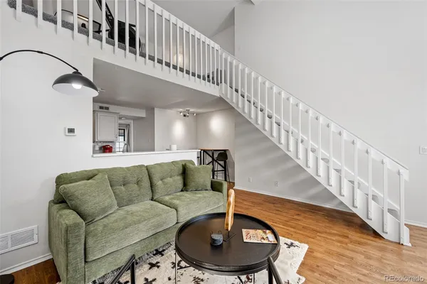 a living room with furniture and a dining table