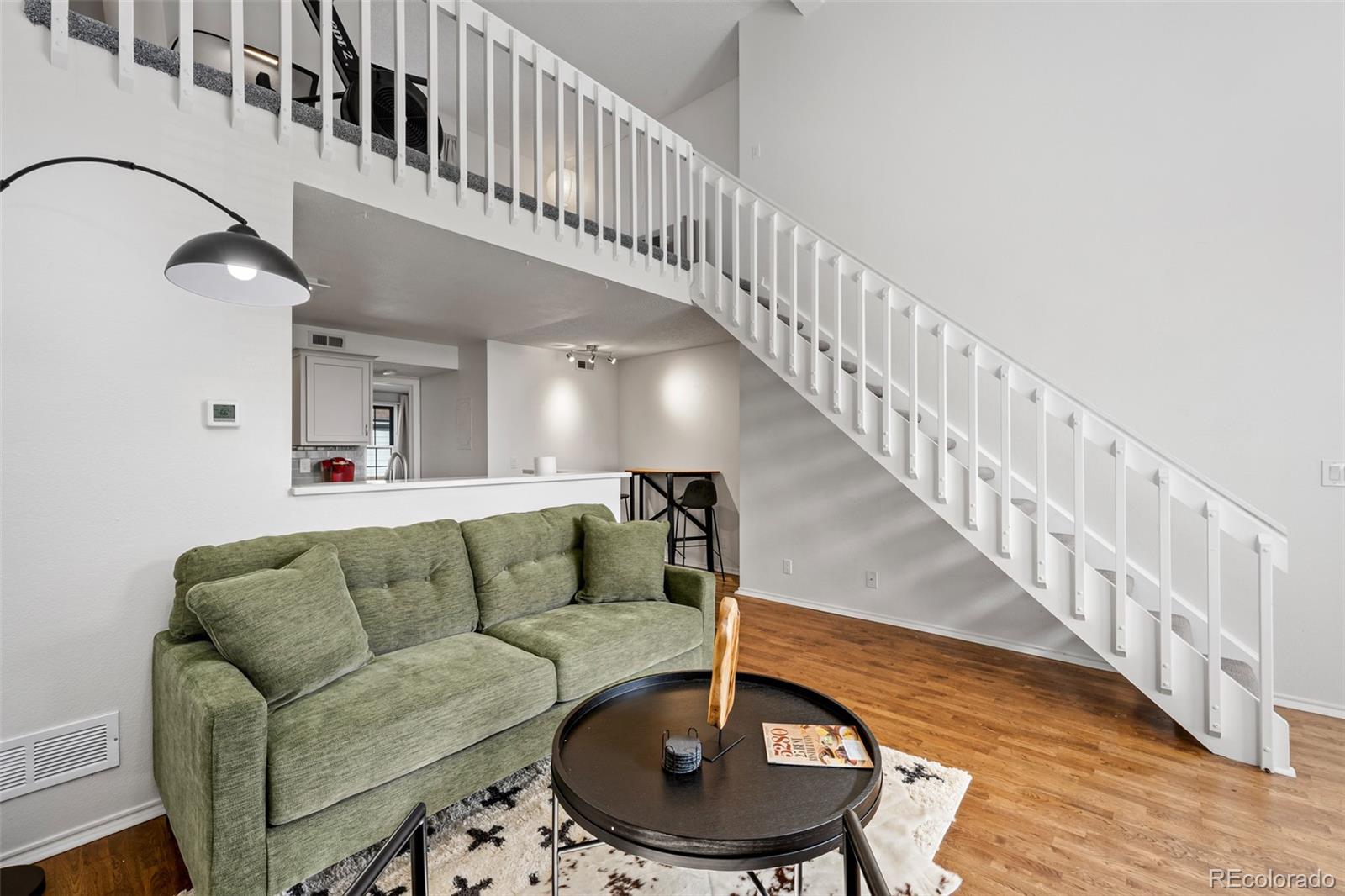 3016 West Prentice Avenue, Unit D Littleton, CO 80123 - Photo 3 of 28 a living room with furniture and a dining table