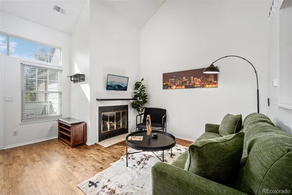 a living room with furniture and a fireplace