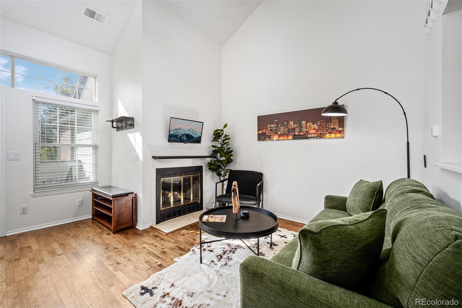 3016 West Prentice Avenue, Unit D Littleton, CO 80123 - Photo 4 of 28 a living room with furniture and a fireplace