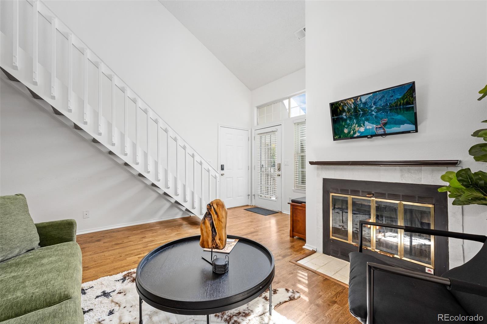 3016 West Prentice Avenue, Unit D Littleton, CO 80123 - Photo 5 of 28 a living room with furniture and a fireplace