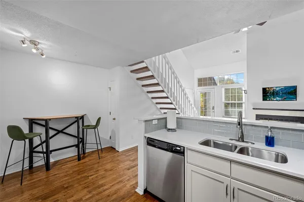 a kitchen with sink cabinets and wooden floor