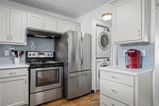 a kitchen with stainless steel appliances granite countertop a stove and a refrigerator