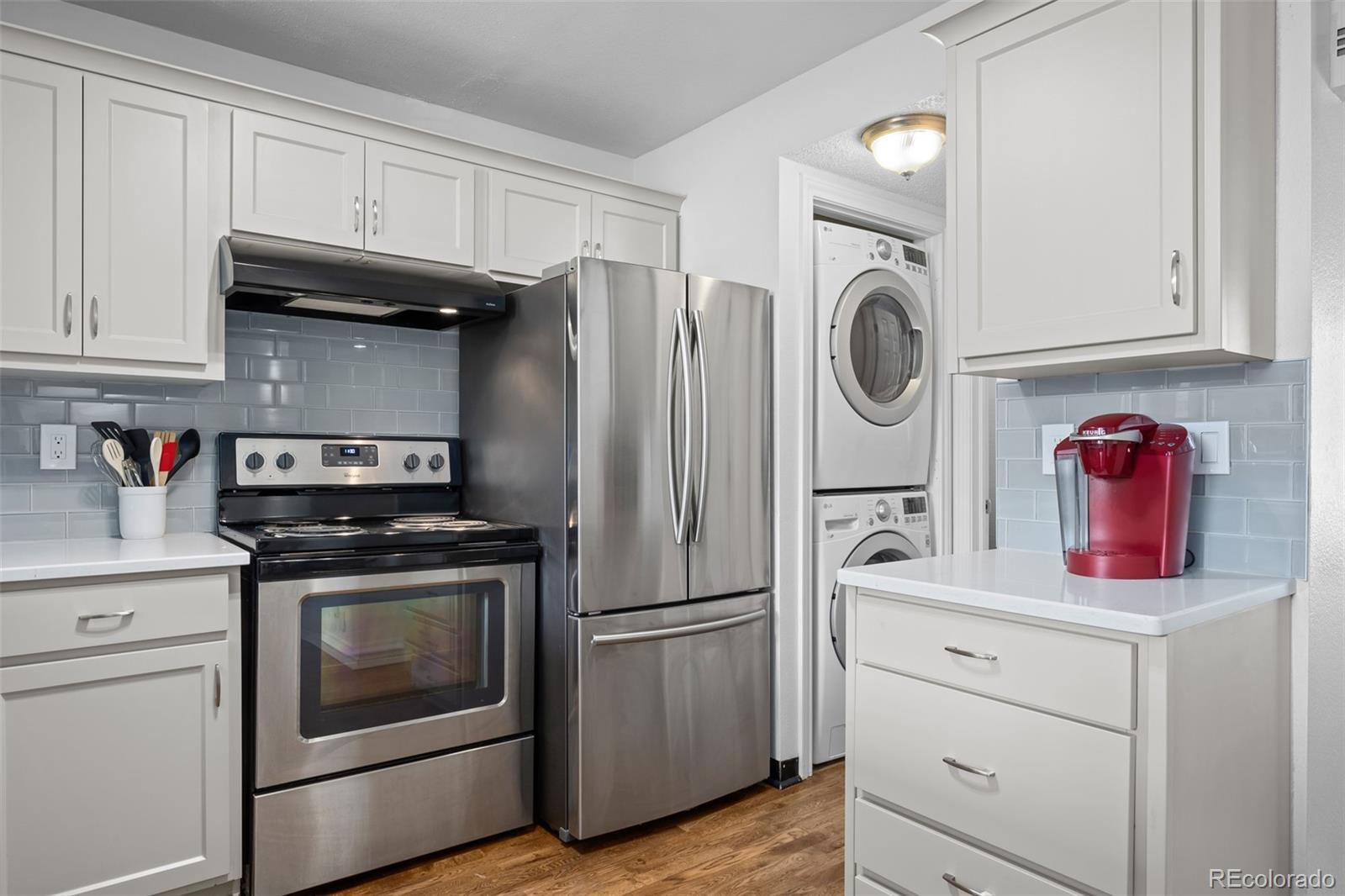 3016 West Prentice Avenue, Unit D Littleton, CO 80123 - Photo 9 of 28 a kitchen with stainless steel appliances granite countertop a stove and a refrigerator