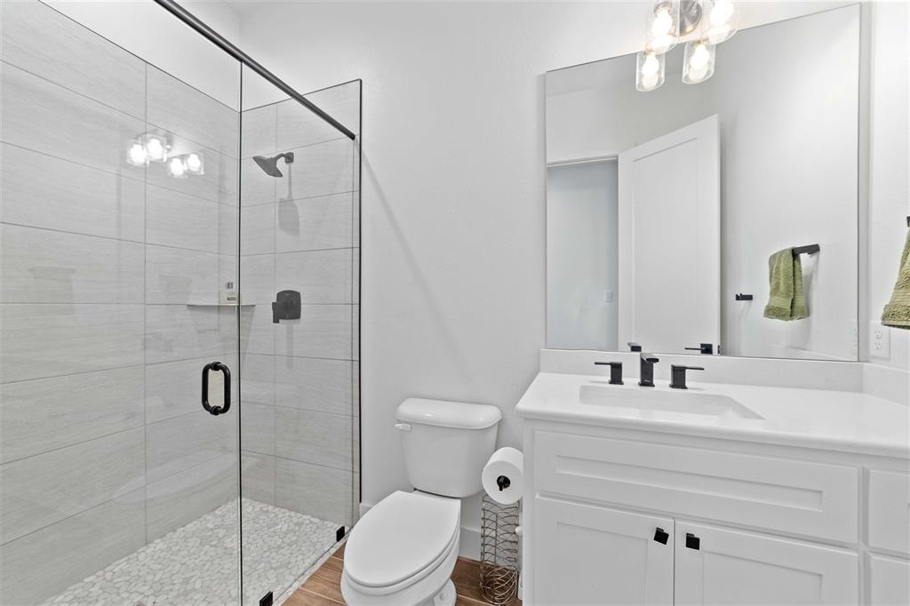 582 Oak Point Drive May, TX 76857 - Photo 22 of 37 a bathroom with a toilet sink shower and mirror