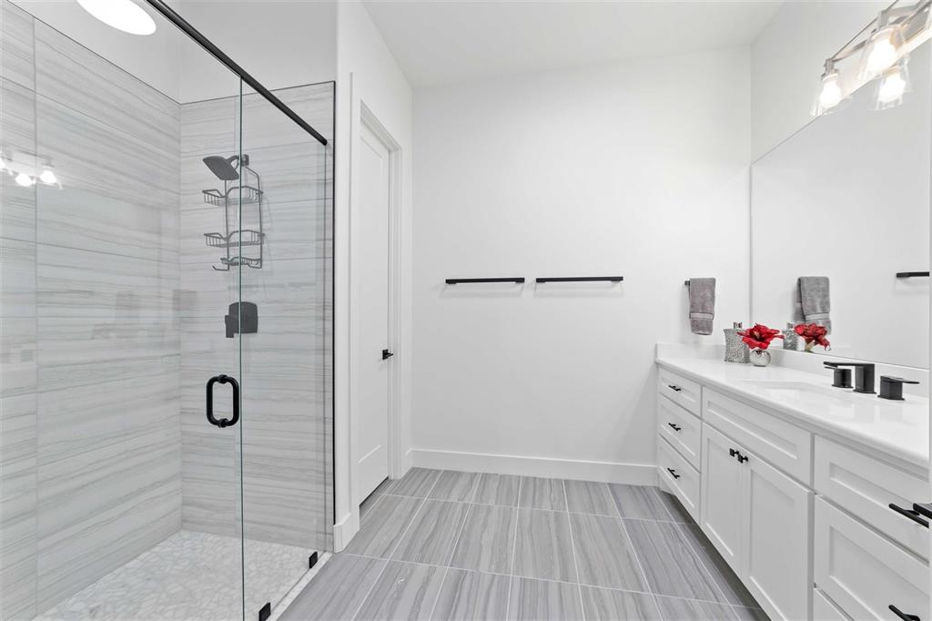 582 Oak Point Drive May, TX 76857 - Photo 24 of 37 a bathroom with a shower sink and mirror