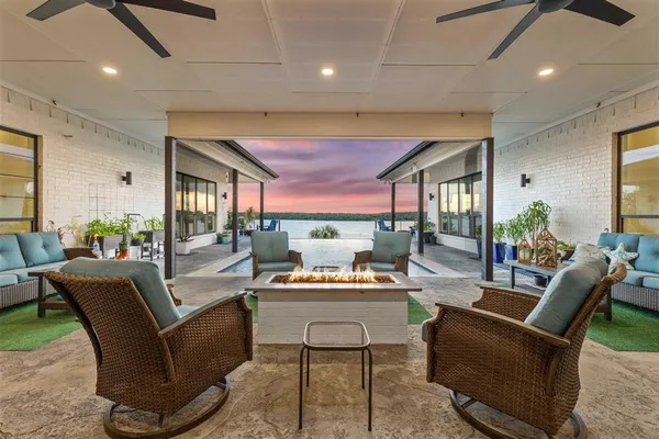 a living room with furniture and floor to ceiling windows