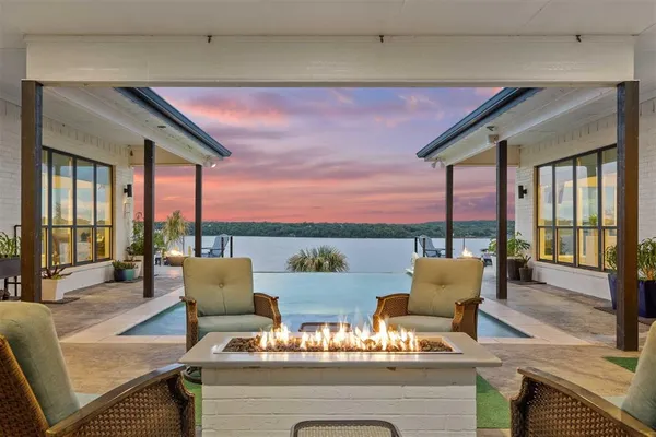 a large kitchen with lots of counter space a sink appliances and a dining table