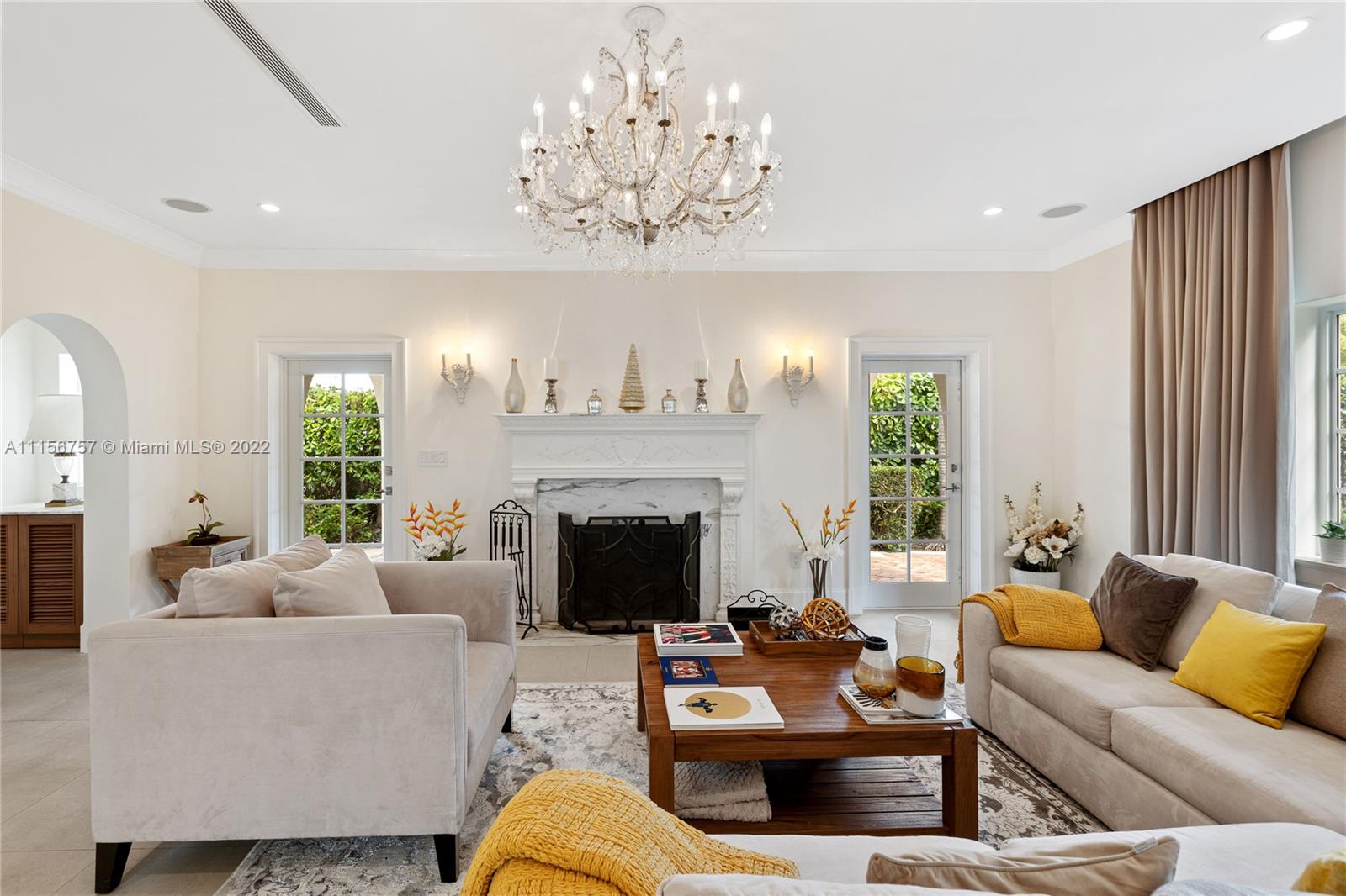 2914 Alton Road Miami Beach, FL 33140 - Photo 17 of 70 a living room with furniture a chandelier and a fireplace