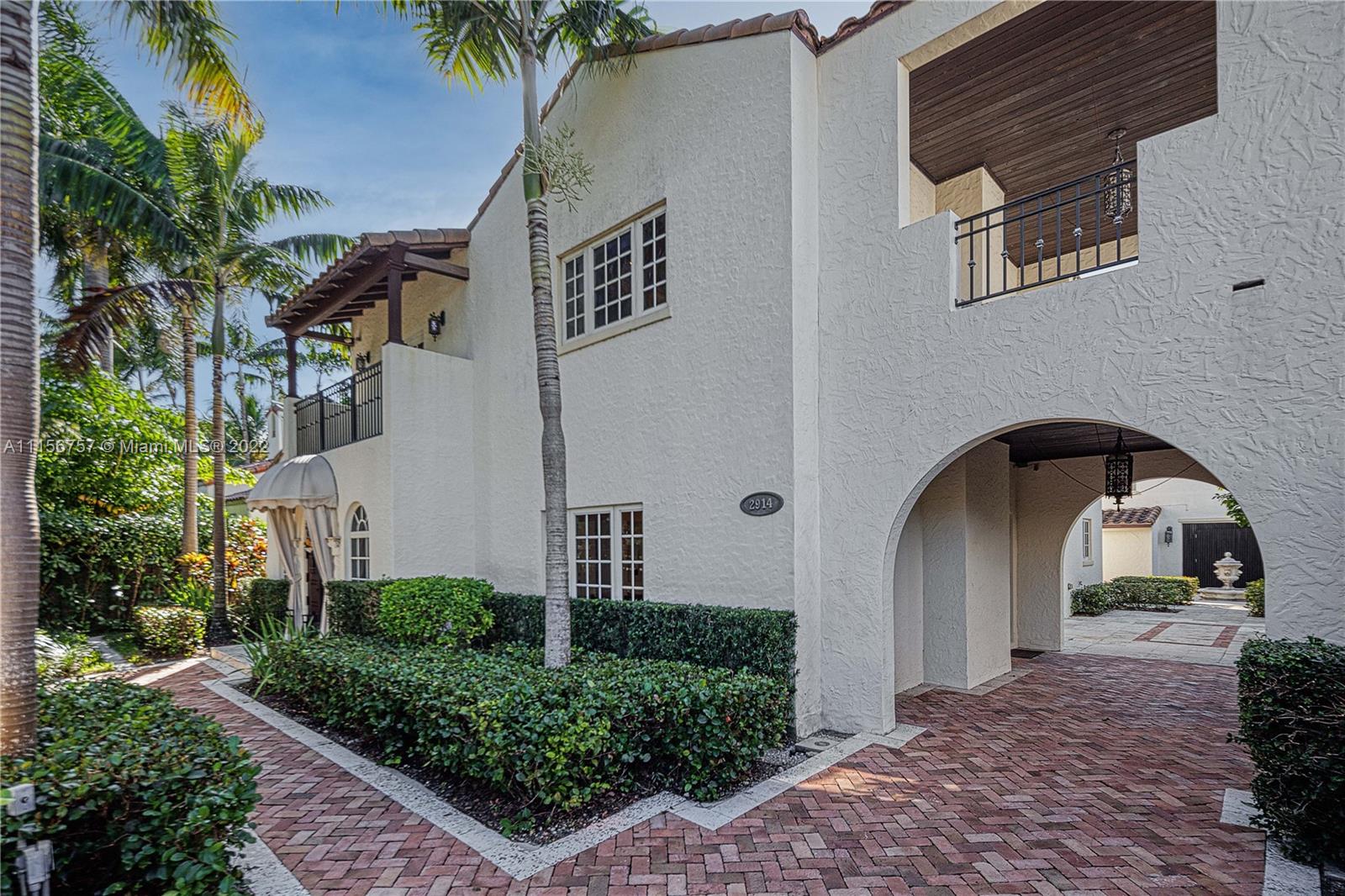 2914 Alton Road Miami Beach, FL 33140 - Photo 24 of 70 a front view of a house with garden