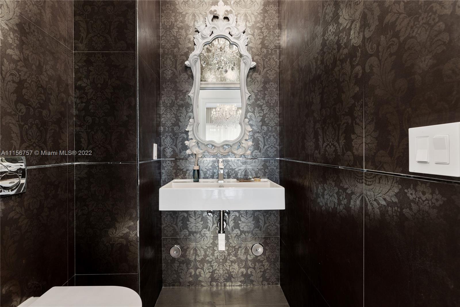 2914 Alton Road Miami Beach, FL 33140 - Photo 27 of 70 a bathroom with a sink a mirror and a shower