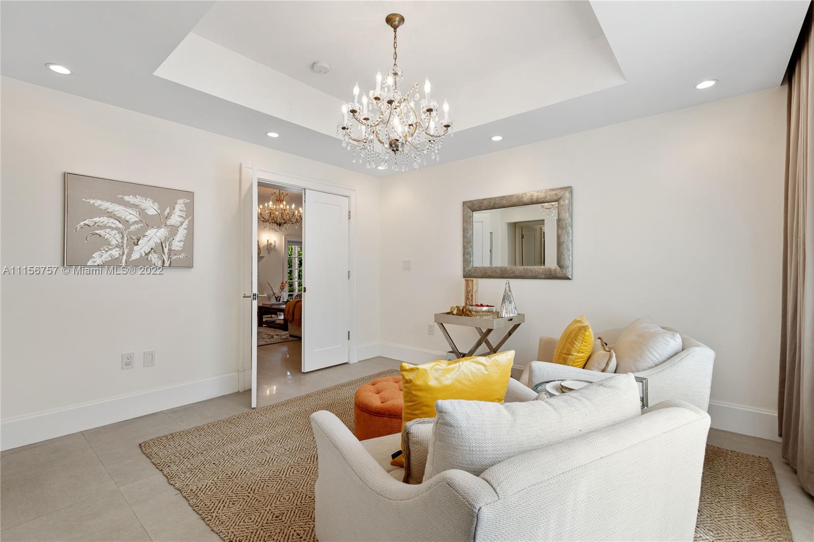 2914 Alton Road Miami Beach, FL 33140 - Photo 29 of 70 a living room with furniture and a chandelier