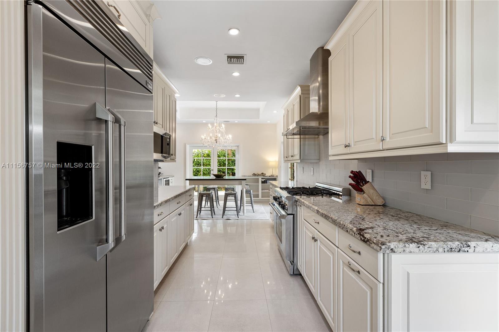 2914 Alton Road Miami Beach, FL 33140 - Photo 32 of 70 a kitchen with stainless steel appliances granite countertop a stove a sink and a refrigerator