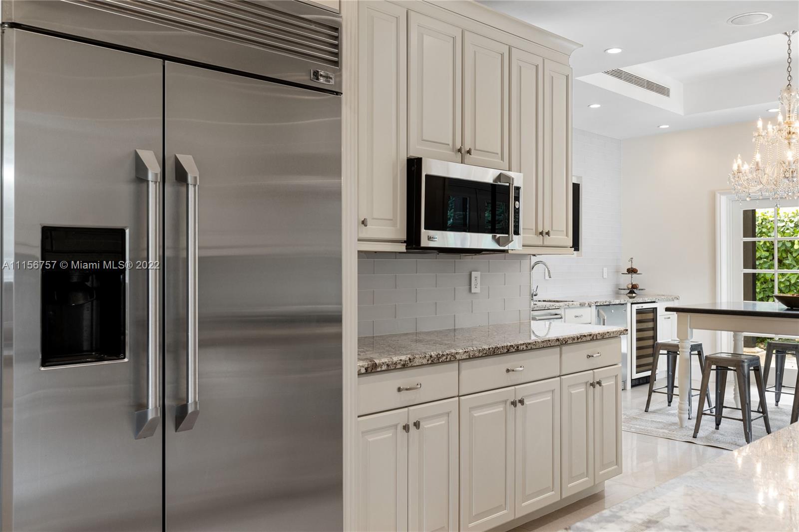 2914 Alton Road Miami Beach, FL 33140 - Photo 34 of 70 a kitchen with stainless steel appliances white cabinets and a sink