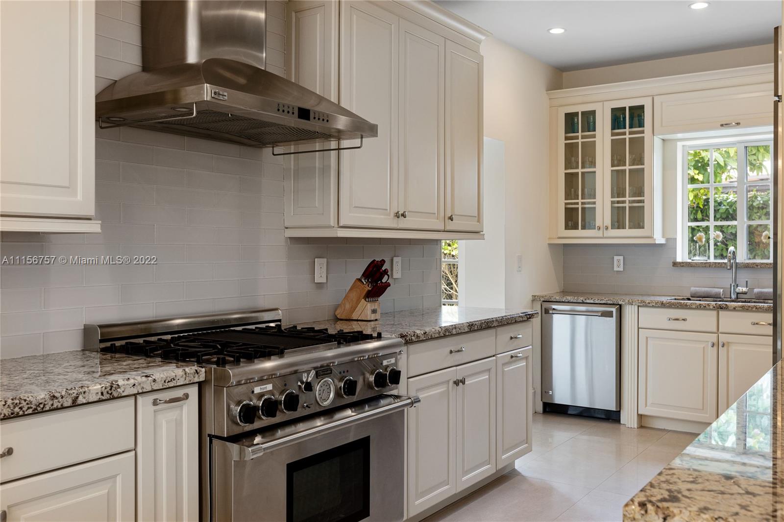 2914 Alton Road Miami Beach, FL 33140 - Photo 35 of 70 a kitchen with stainless steel appliances granite countertop a stove and a sink