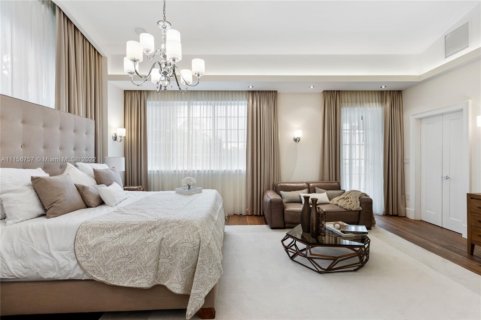 2914 Alton Road Miami Beach, FL 33140 - Photo 40 of 70 a bedroom with a bed and ceiling chandelier