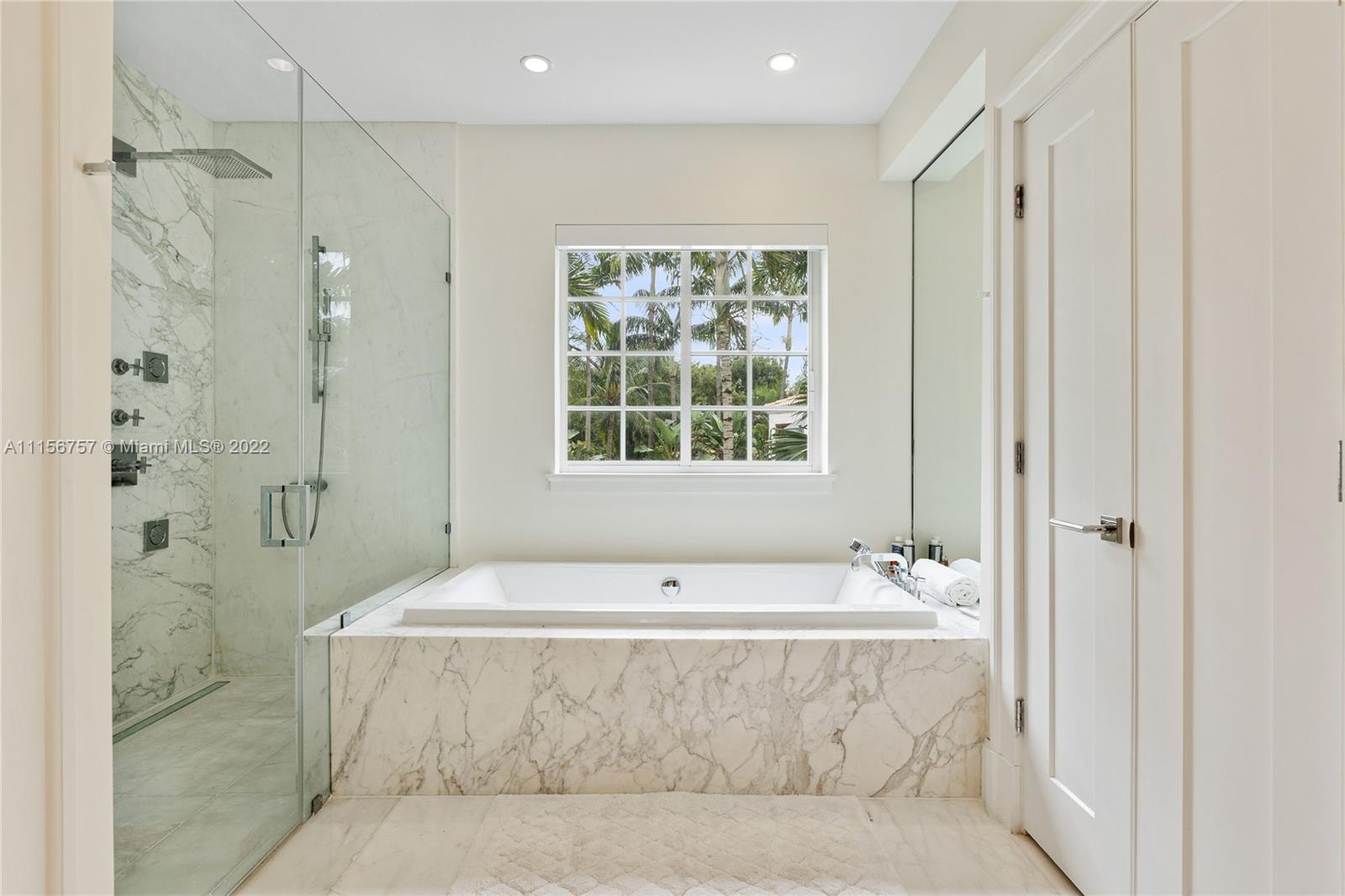 2914 Alton Road Miami Beach, FL 33140 - Photo 43 of 70 a spacious bathroom with shower bathtub and window
