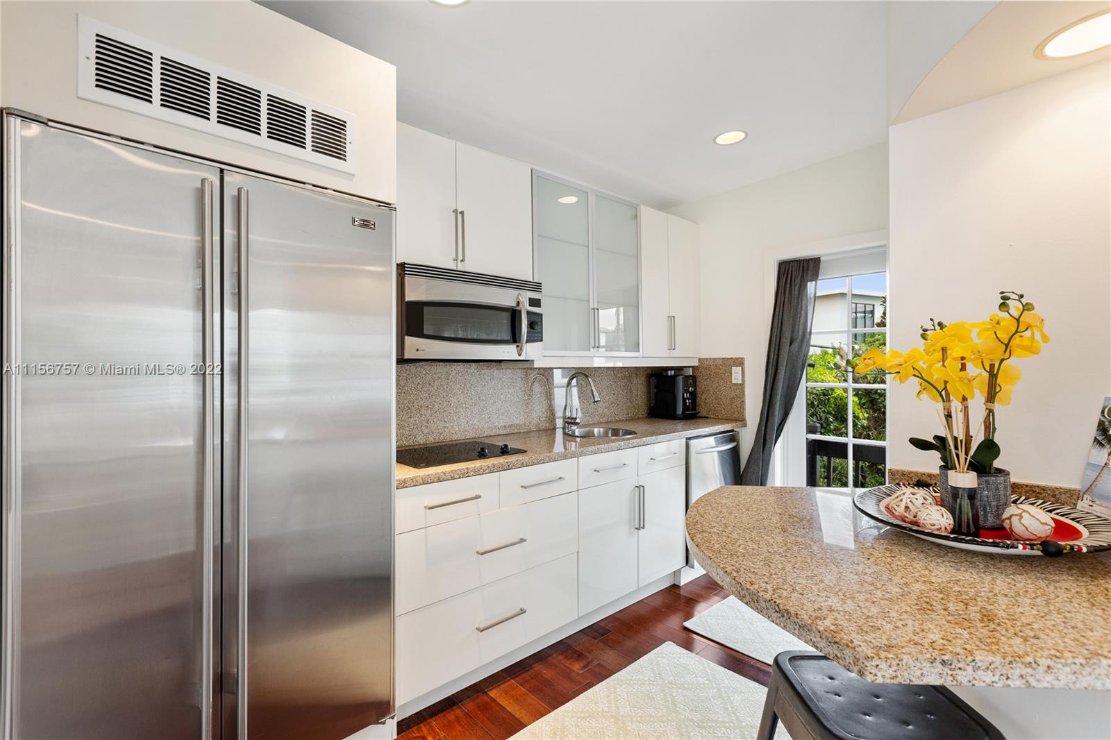 2914 Alton Road Miami Beach, FL 33140 - Photo 62 of 70 a kitchen with stainless steel appliances granite countertop a refrigerator and a stove top oven