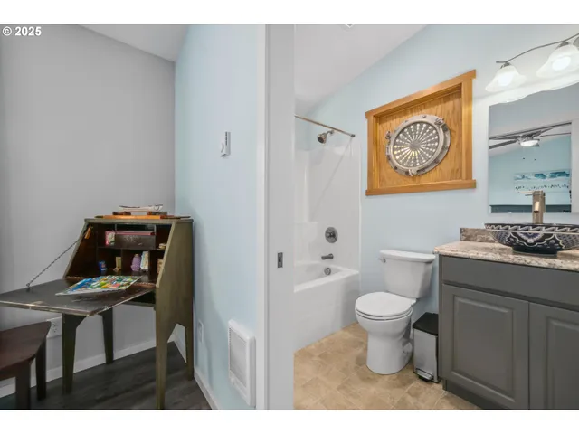 a bathroom with a toilet a sink and a mirror