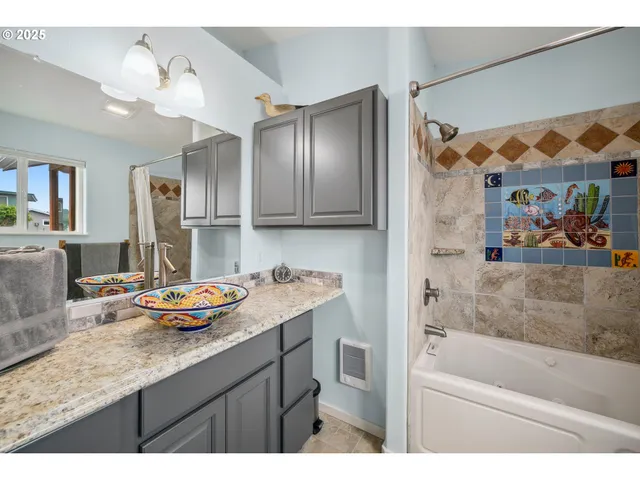 a bathroom with a tub sink and mirror
