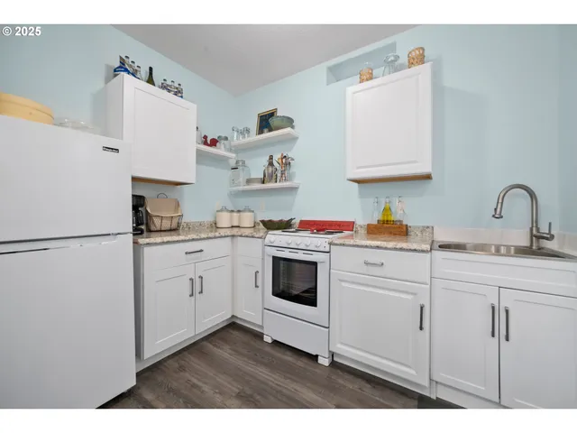 a kitchen with cabinets appliances and a sink
