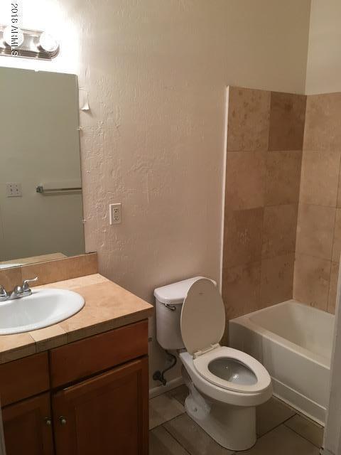 7110 North 68th Avenue, Unit 1 Glendale, AZ 85303 - Photo 17 of 22 a bathroom with a sink a toilet and bathtub