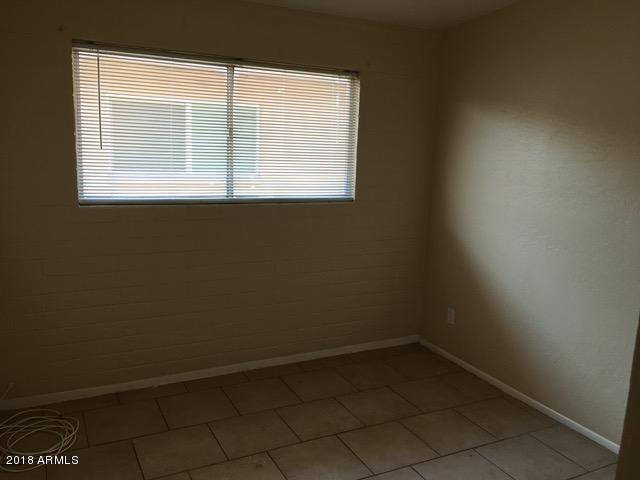 7110 North 68th Avenue, Unit 1 Glendale, AZ 85303 - Photo 19 of 22 an empty room with a window