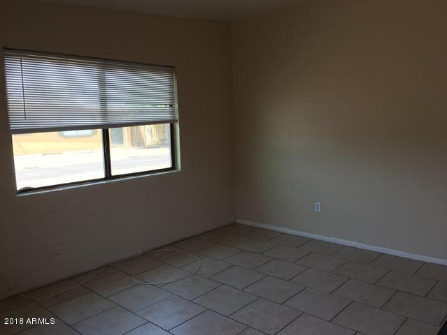 7110 North 68th Avenue, Unit 1 Glendale, AZ 85303 - Photo 3 of 22 an empty room with a window