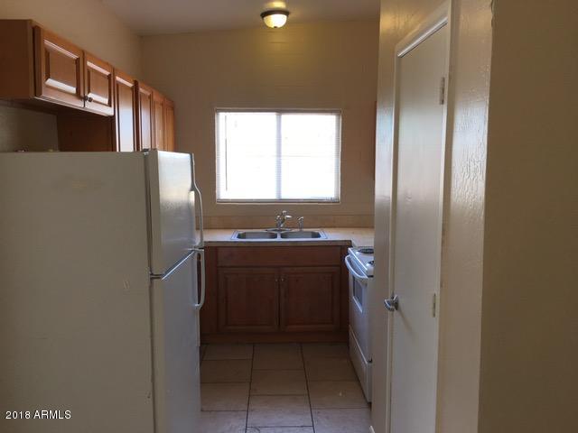 7110 North 68th Avenue, Unit 1 Glendale, AZ 85303 - Photo 8 of 22 a kitchen with stainless steel appliances granite countertop a refrigerator and a sink